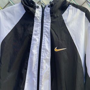 white and gold nike windbreaker